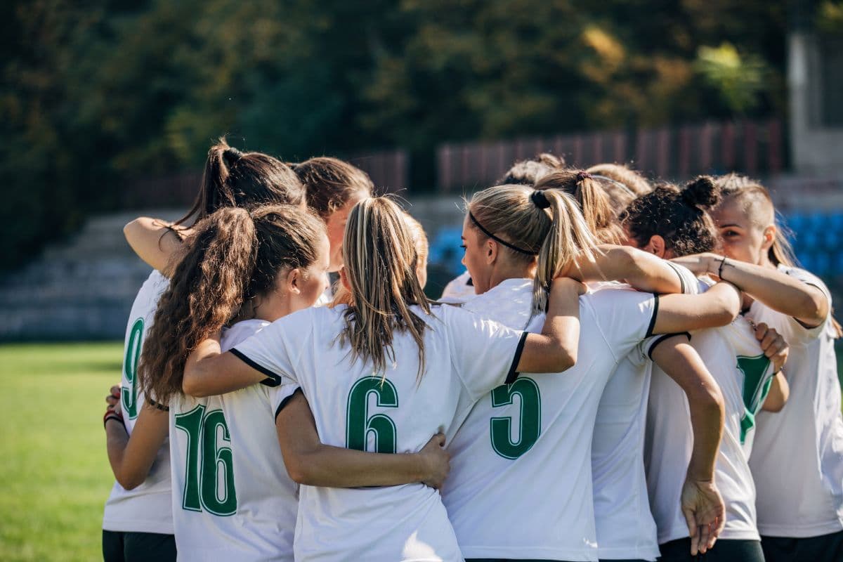 female soccer players in huddle