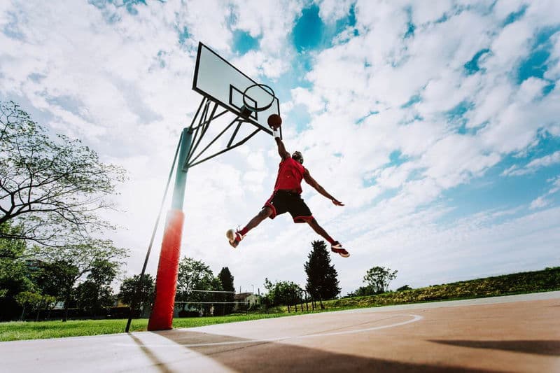 a man dunks a basketball in the iconic michael jordan pose